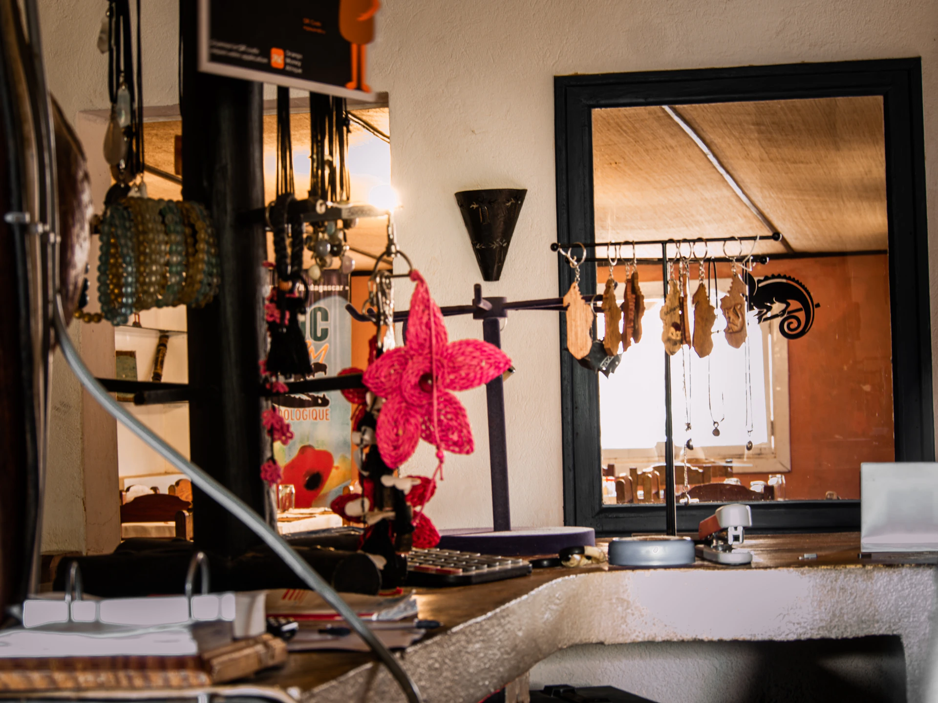 A cozy display corner of the parineetacollection store with colorful necklaces hanging against a soft pastel backdrop.