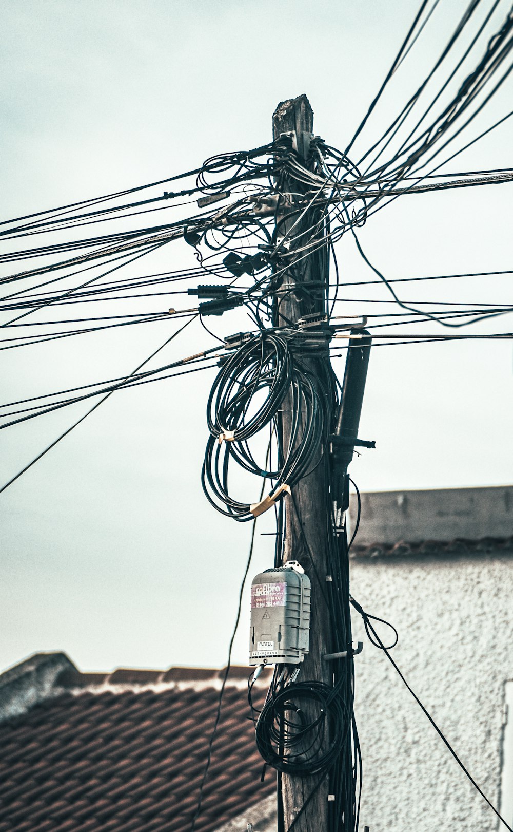 a bunch of wires and wires hanging from a pole