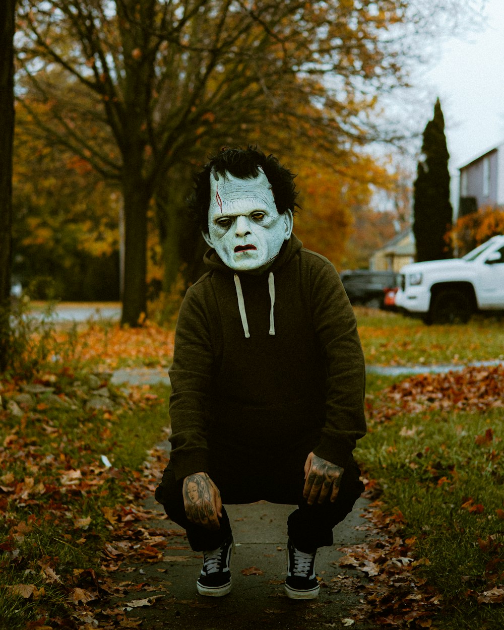 a man in a costume sitting on a curb