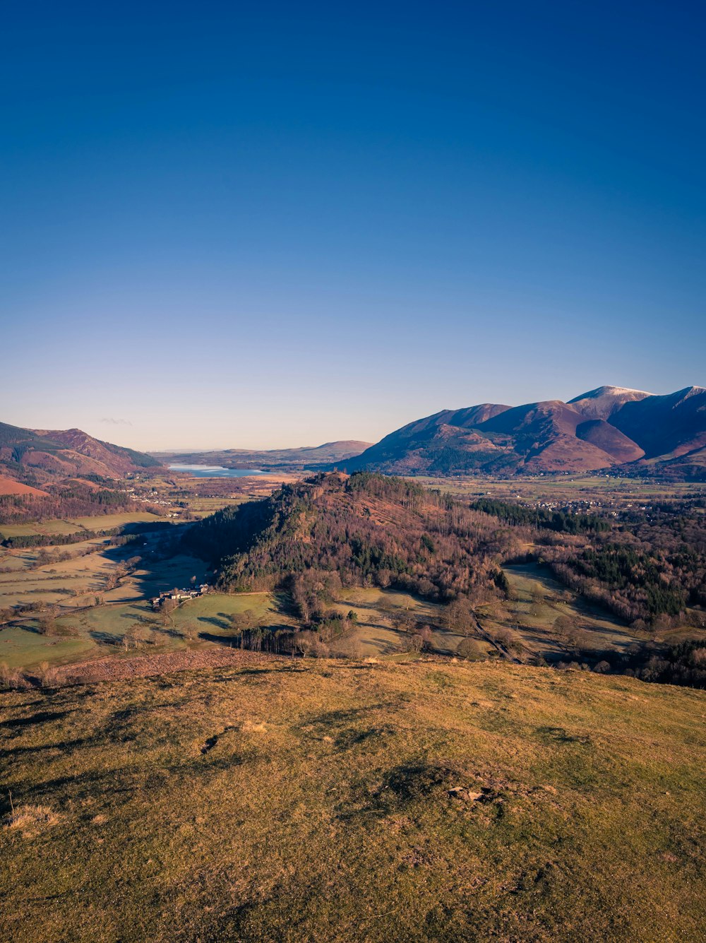 a view of a valley with mountains in the background