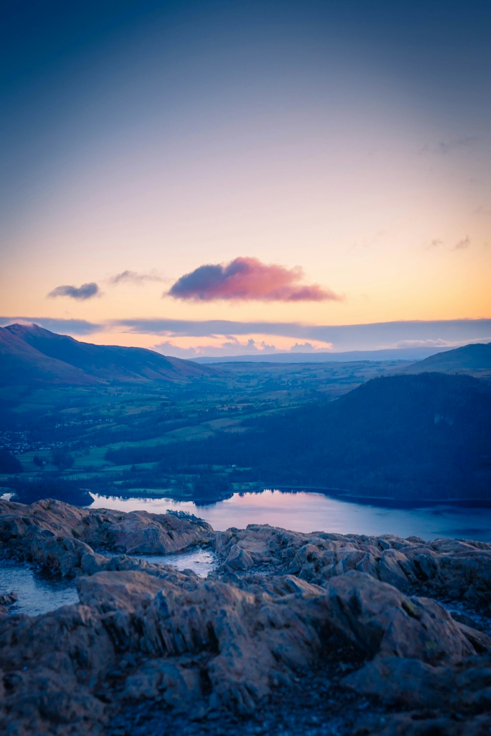 a view of a mountain range with a lake in the foreground