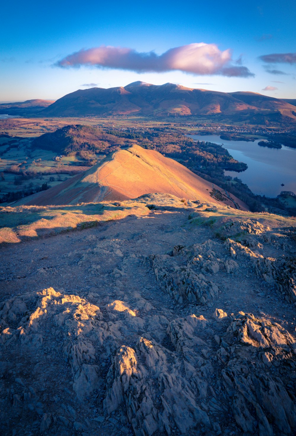 a view of a mountain with a lake in the distance