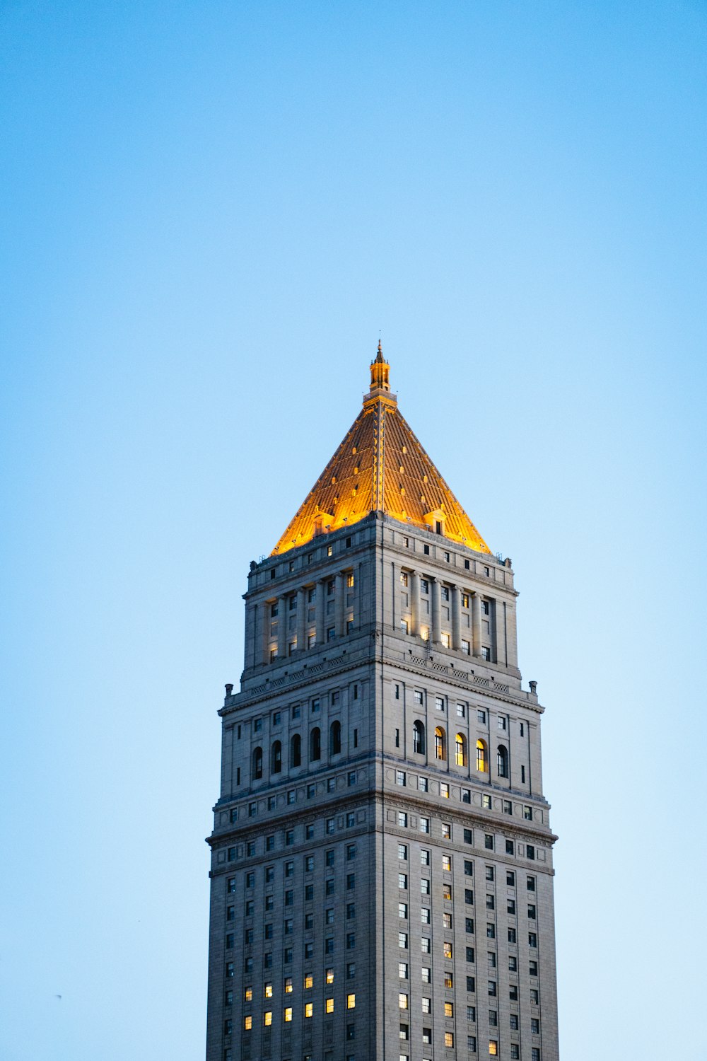 a very tall building with a golden top
