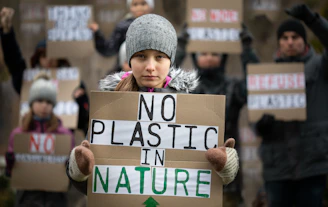 A group holding signs promoting no littering at a local event.