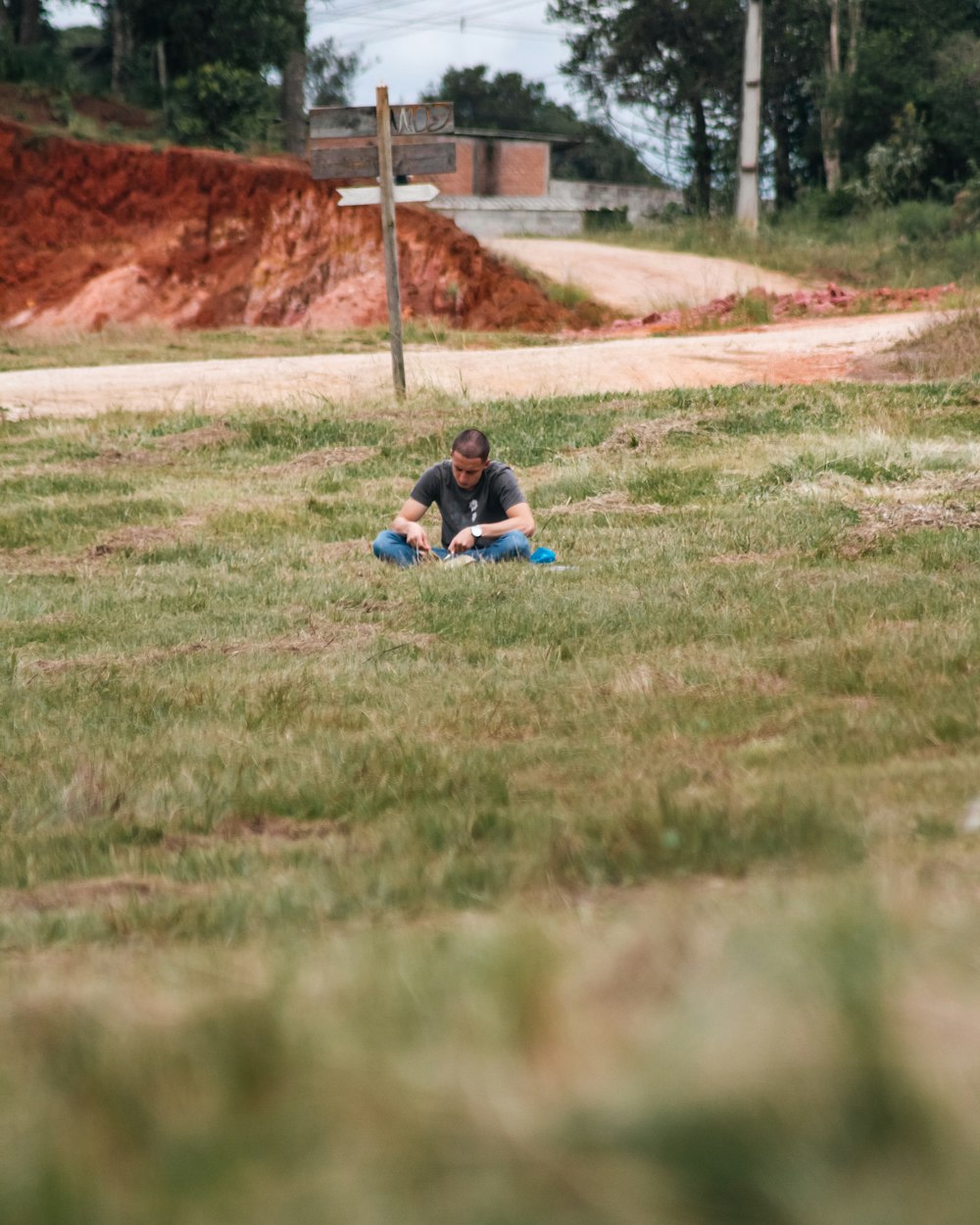 a person laying in the grass with a frisbee