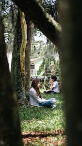 Two mental health professionals in a calm, natural outdoor setting near trees.
