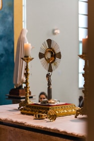 a church altar with a cross and a candle