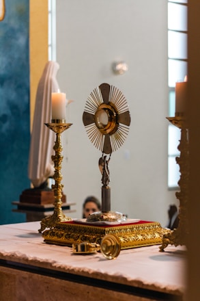 a church altar with a cross and a candle