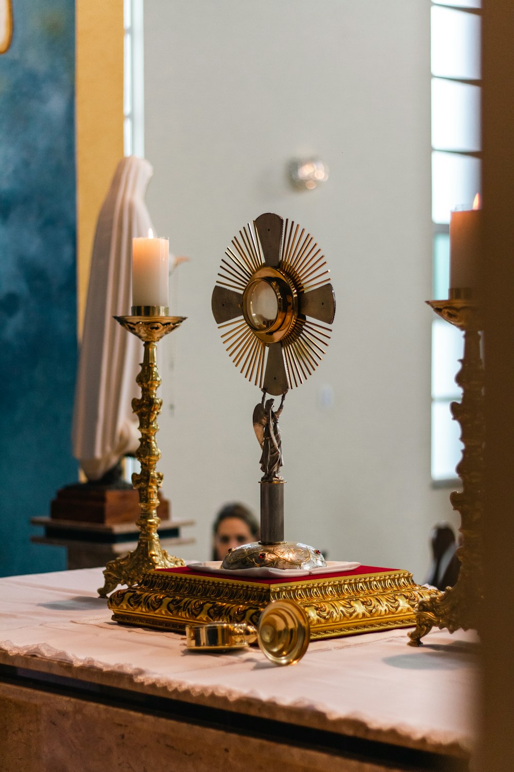 a church altar with a cross and a candle