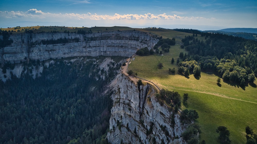 an aerial view of a mountain with a road going through it