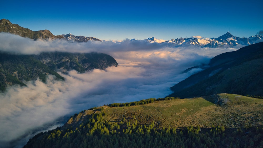 a view of a mountain range covered in clouds