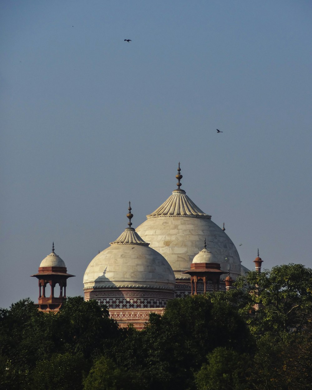 a large white building with two domes on top of it