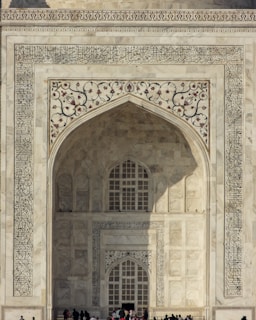 a group of people standing in front of a white building