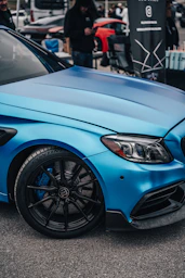 a blue car parked in a parking lot