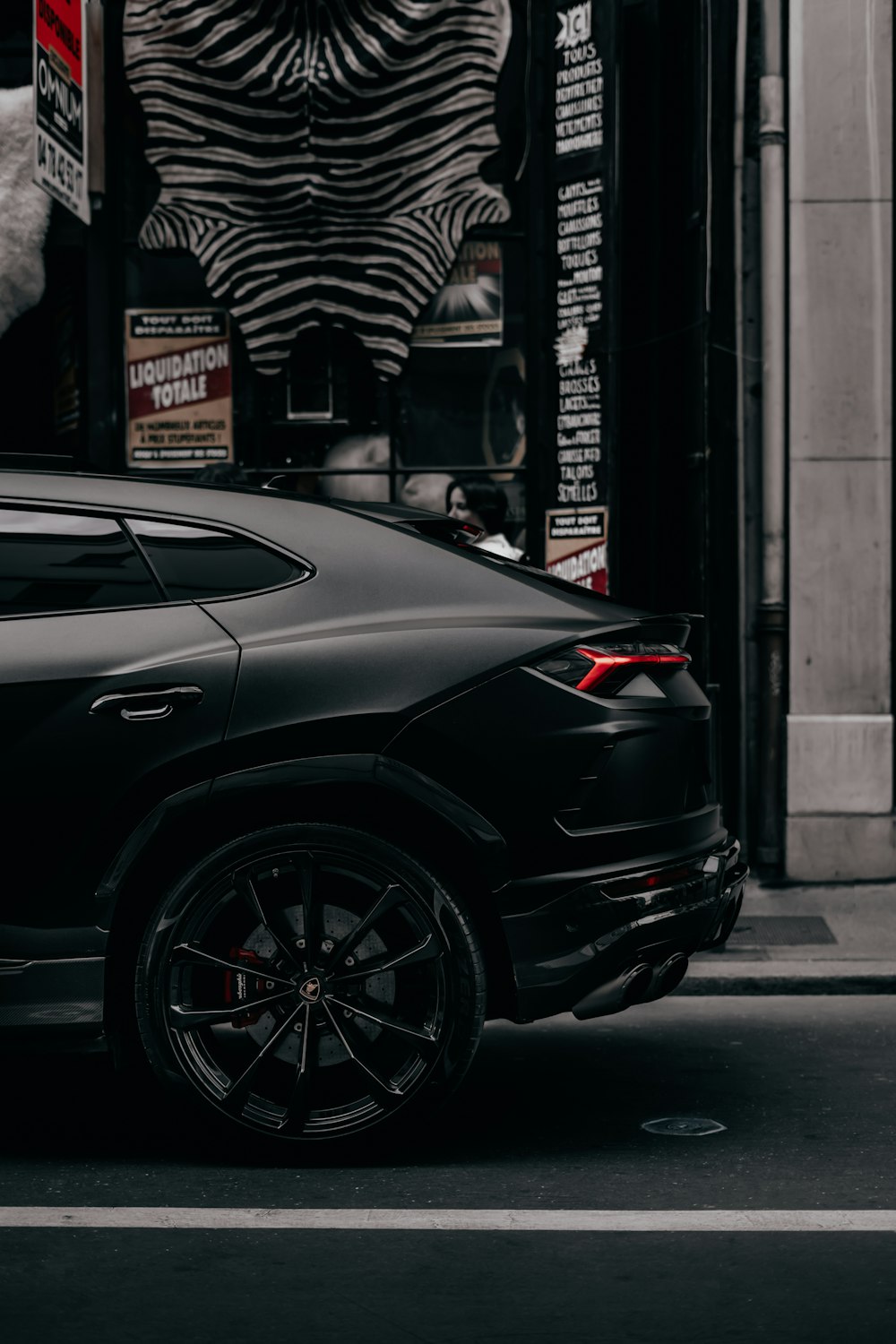 a black car parked on the side of the road