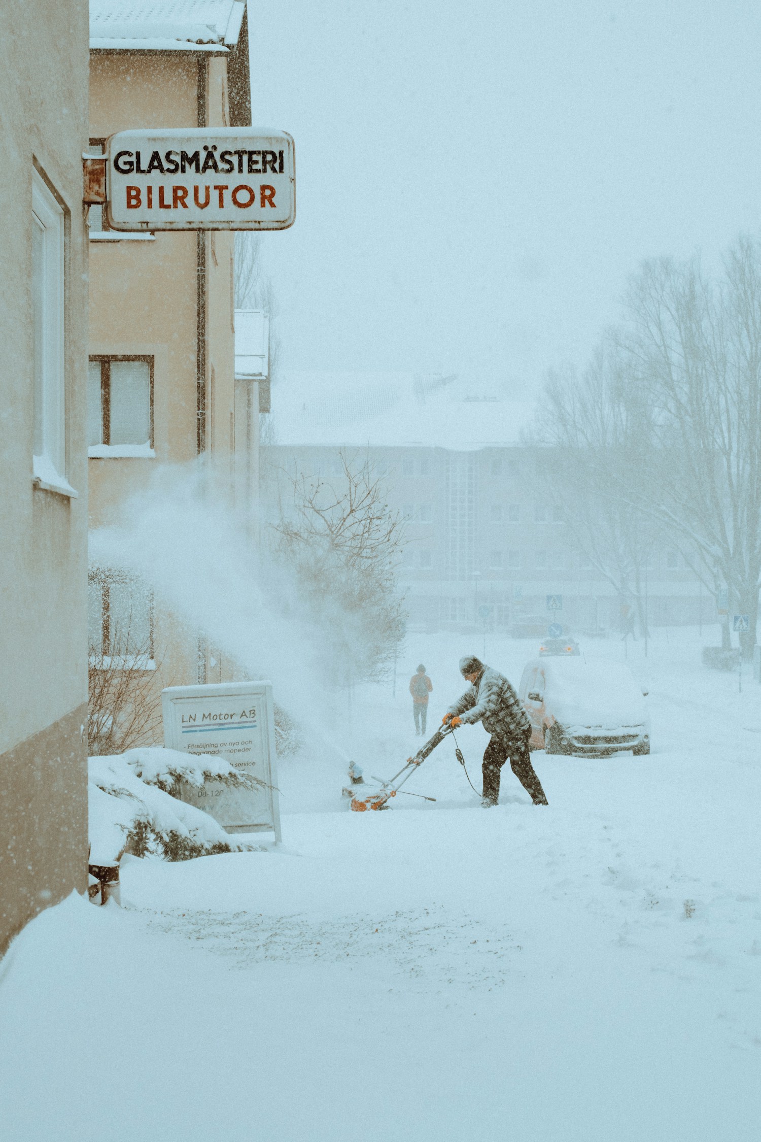 Professional snow plow truck clearing commercial parking lot