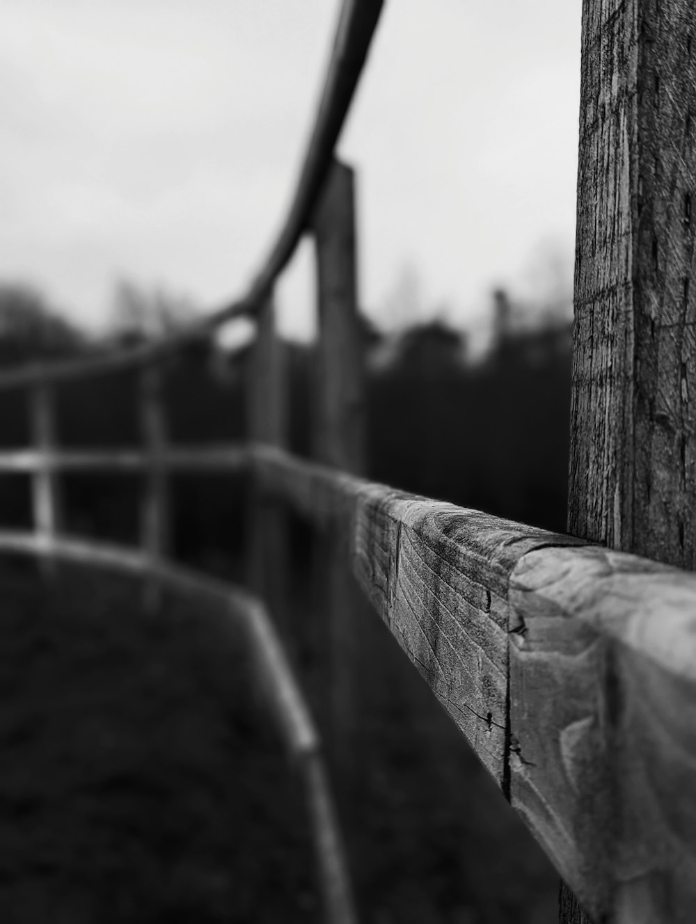 a black and white photo of a wooden fence