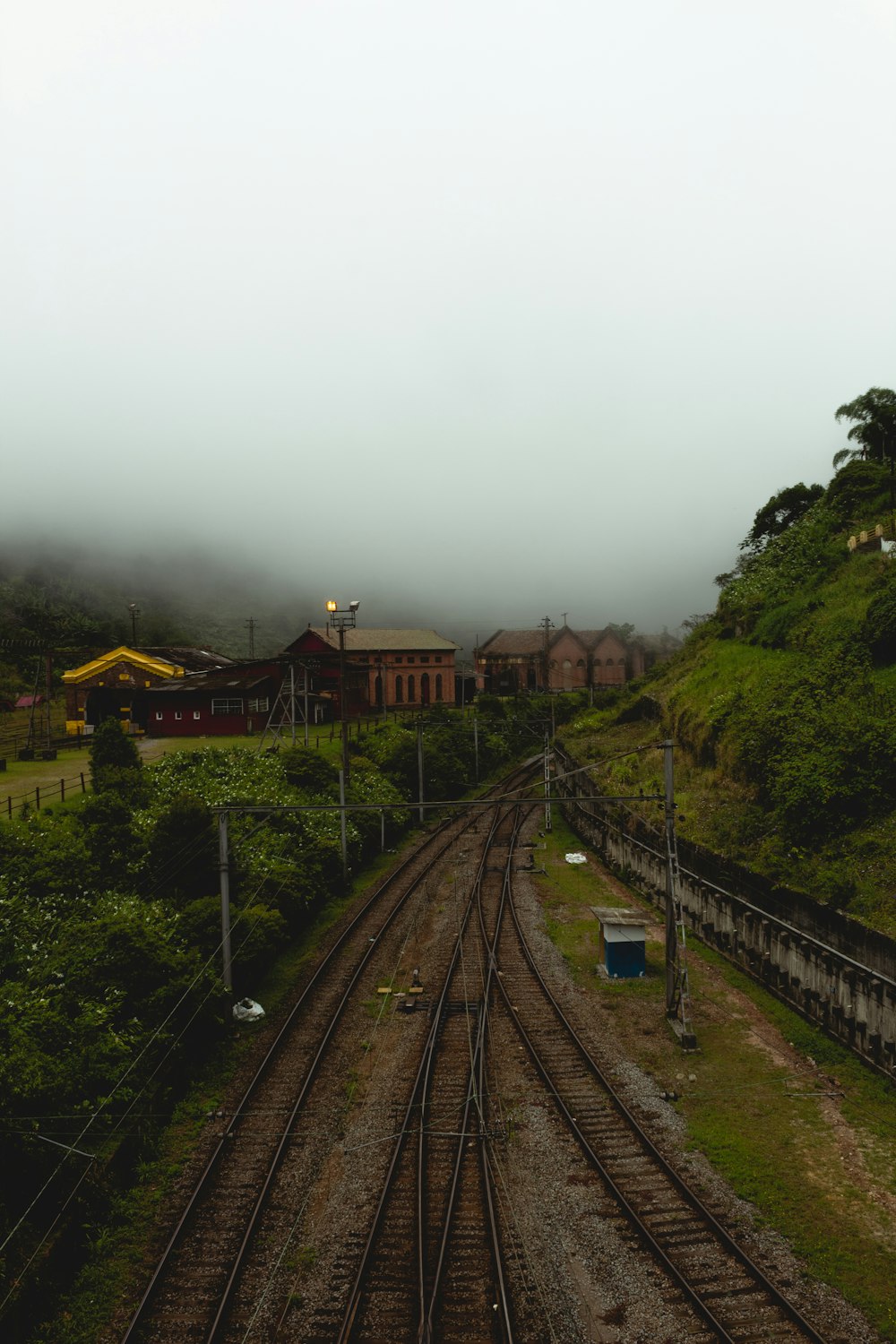 a train track with a train station in the background