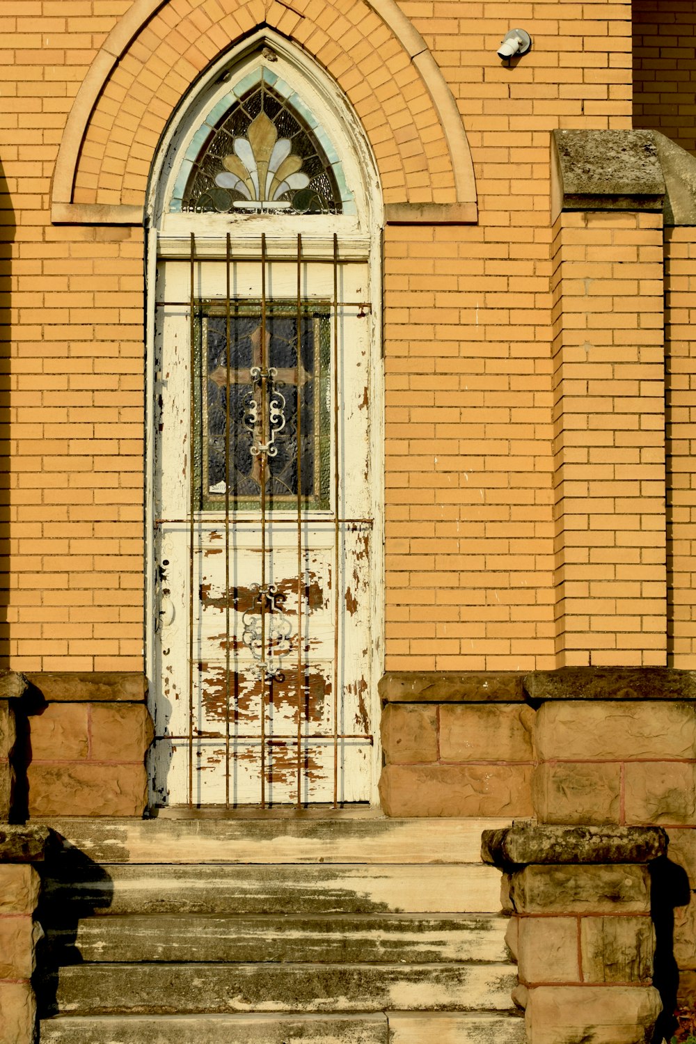 an old church door with a wrought iron gate