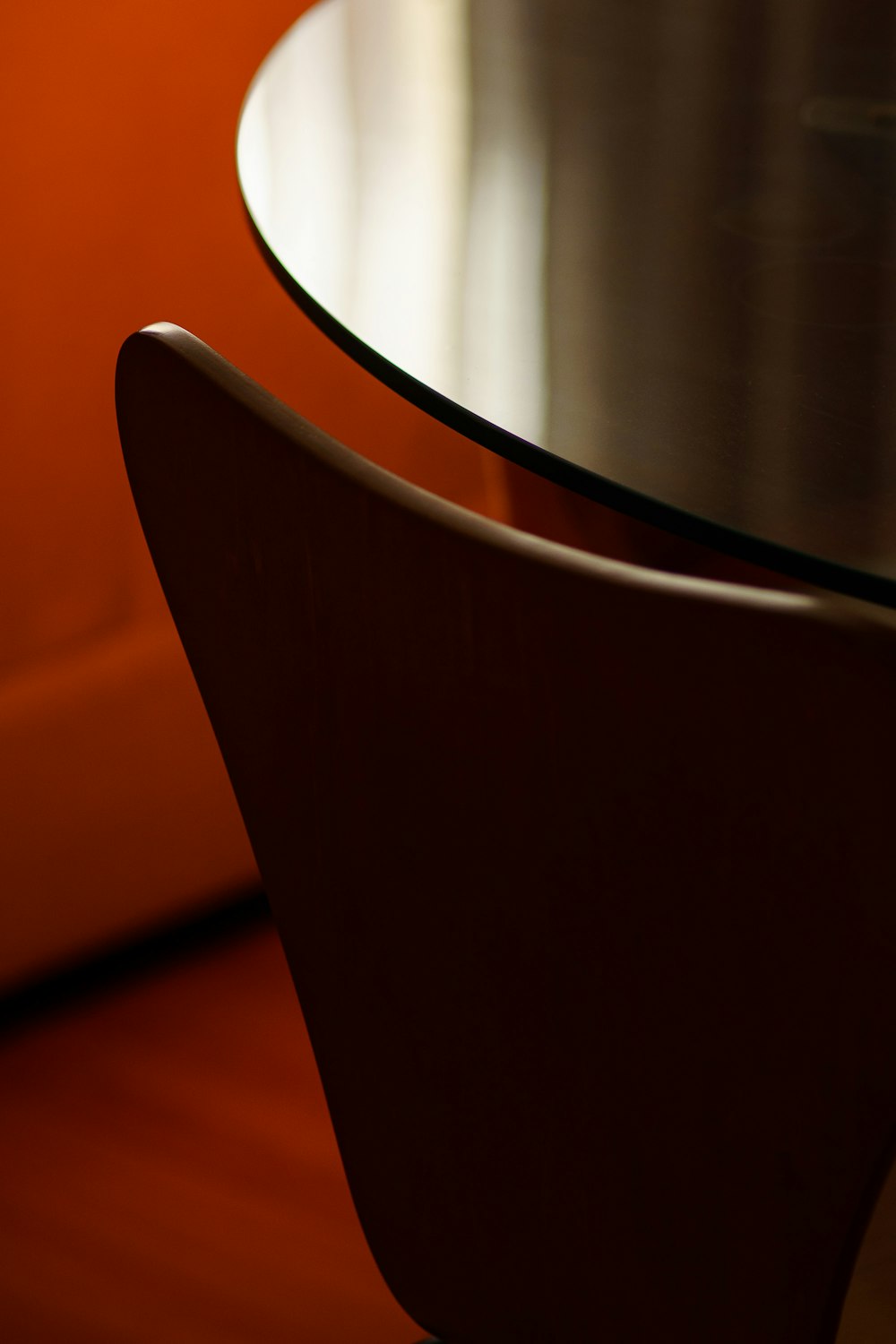 a close up of a table with an orange chair in the background