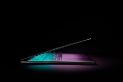 A sleek, dark-themed tech gadget with neon blue accents glowing softly.