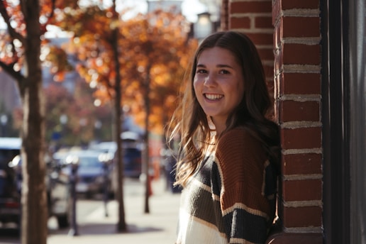 A candid photo of Praveen Madaan smiling against a vibrant Delhi street backdrop.