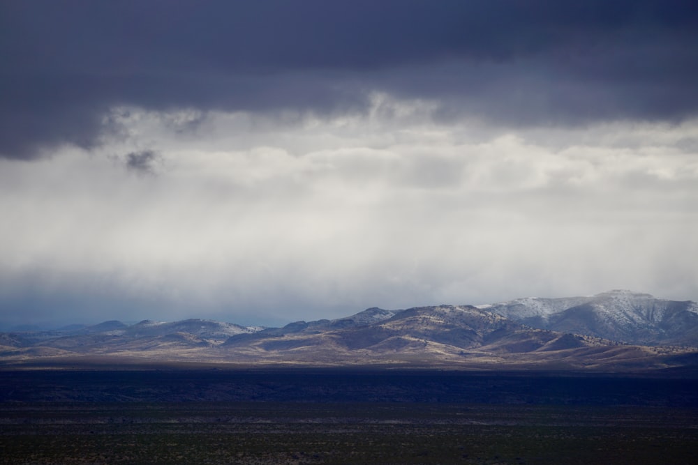 a view of a mountain range under a cloudy sky