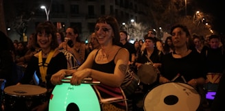 a group of people playing drums in front of a crowd