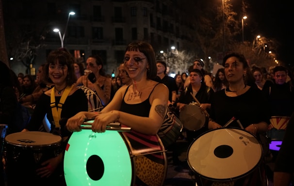 a group of people playing drums in front of a crowd