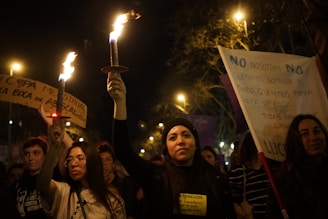 a group of people holding up signs and torches