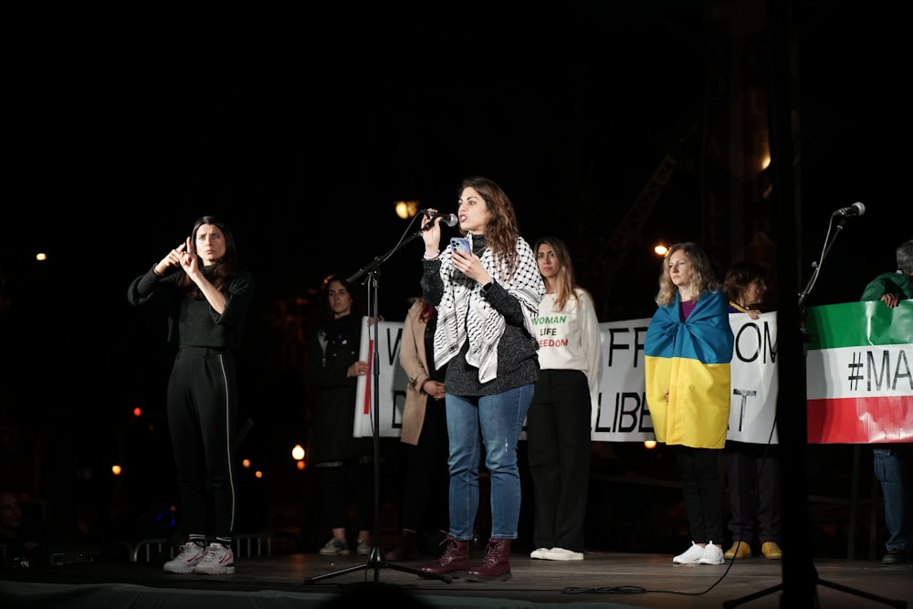 a group of people standing on top of a stage