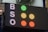 A large electronic scoreboard displays the letters 'B', 'S', and 'O' on the left side with corresponding colored dots to the right. The dots are arranged vertically in a traffic-light style, with green, yellow, and red illuminated next to each letter.