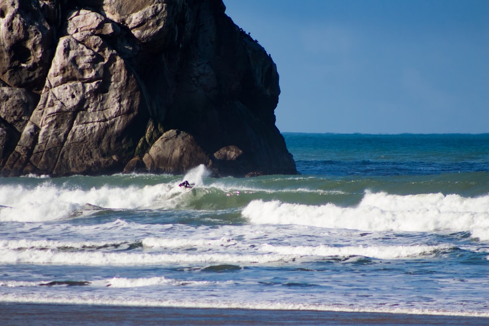 a person riding a surfboard on a wave in the ocean