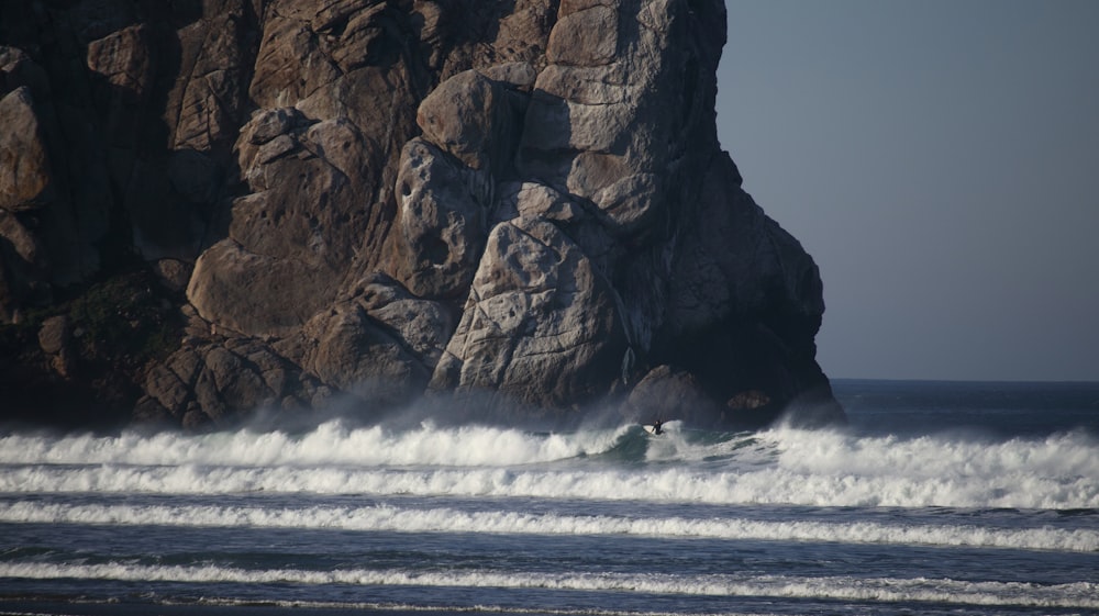 a person riding a surfboard on top of a wave