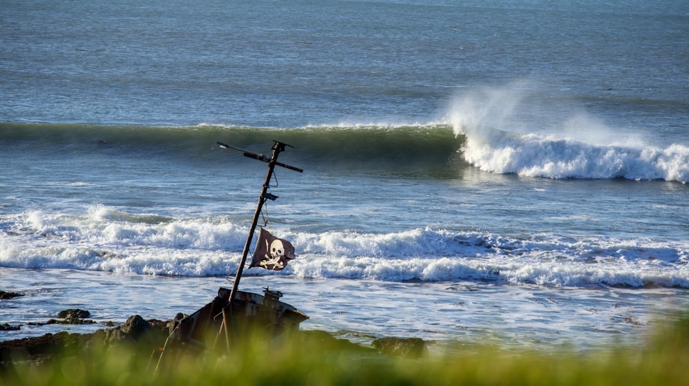 a cross on a rock near the ocean