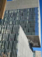 Completed commercial building with glass facade and signage.