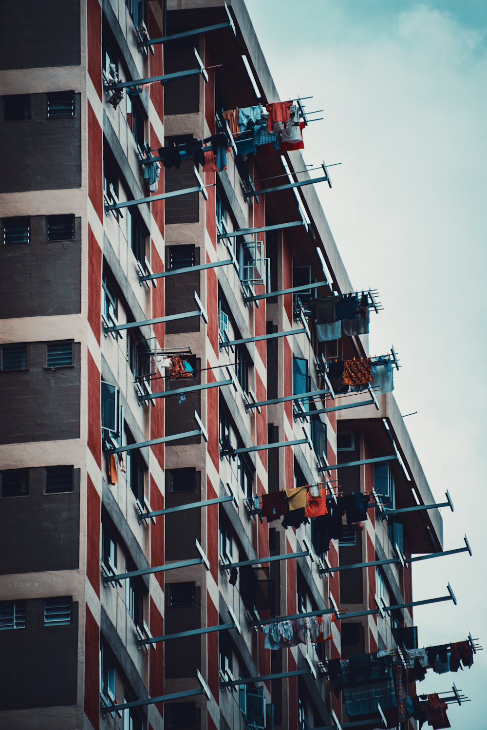 a tall red and white building with scaffolding on it