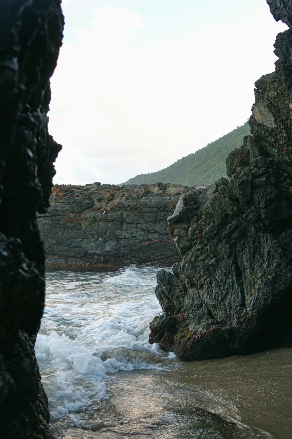 a person standing on a beach next to the ocean