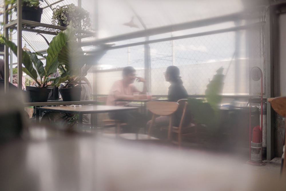 a blurry photo of two people sitting at a table