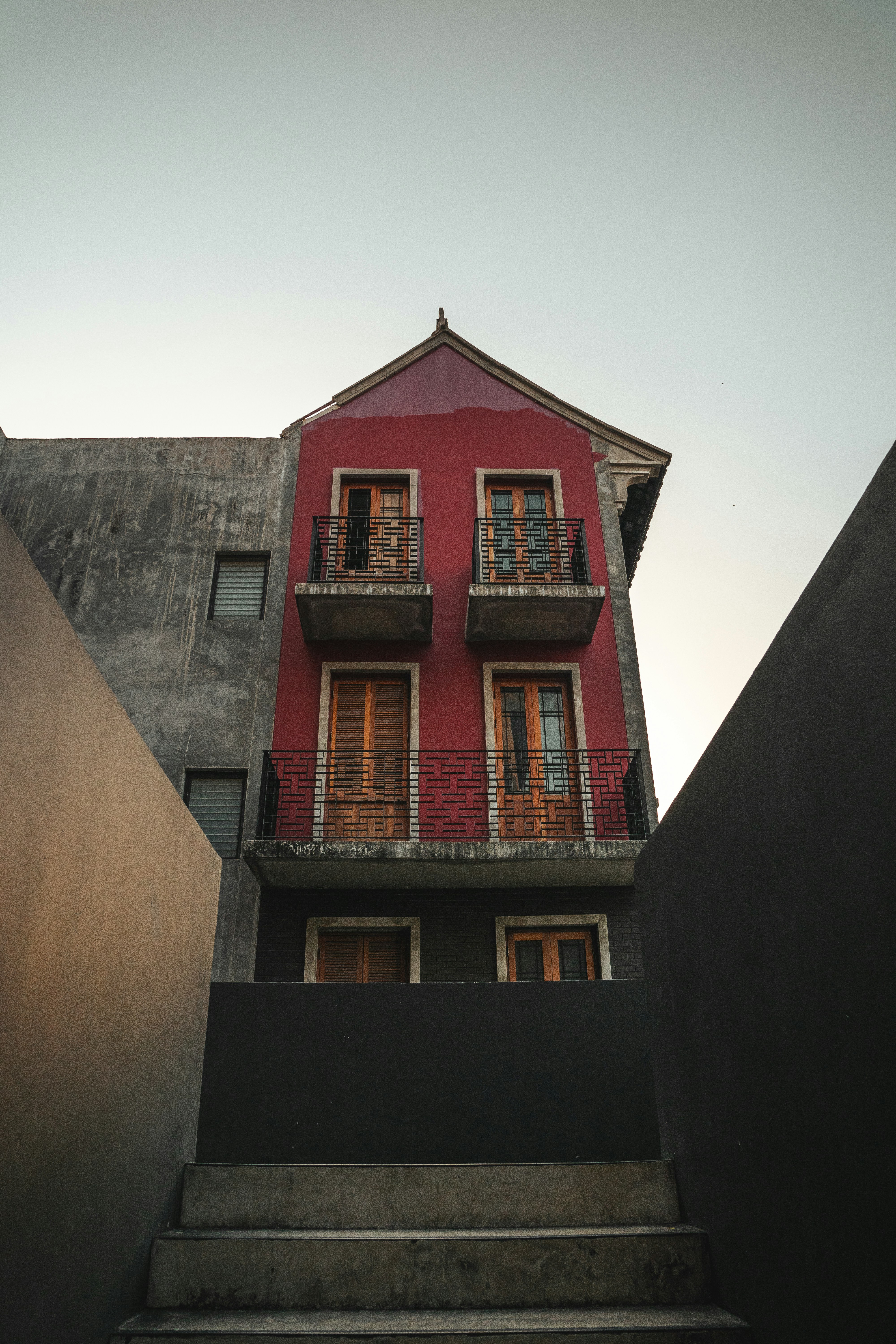 a red building with balconies on the second floor