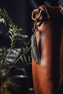 Close-up of leather keychains with brass hardware, capturing the rugged yet refined details of each piece.