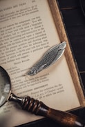 Close-up of an open novel with a vintage bookmark resting on the pages.