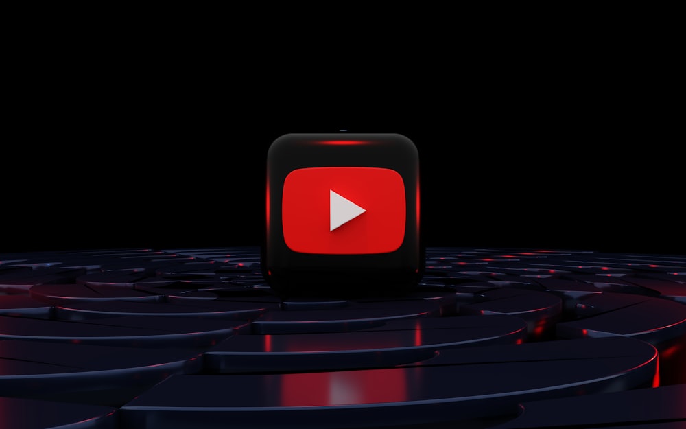 a red play button on a black background