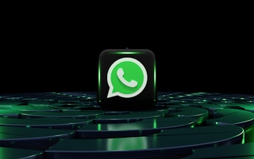 a green whatsapp icon sitting on top of a maze