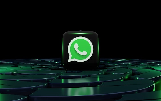 a green whatsapp icon sitting on top of a maze