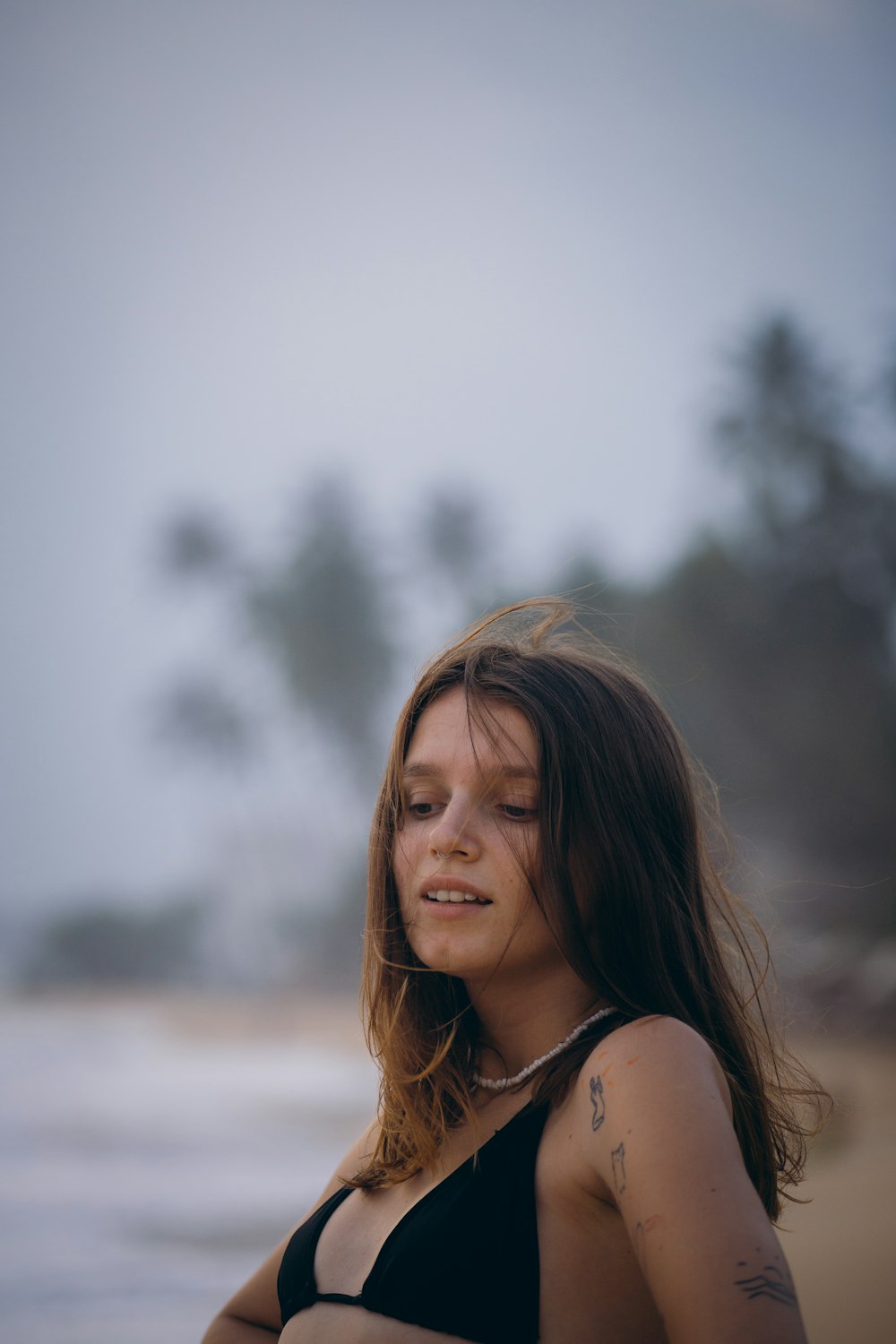 a woman in a bikini standing on the beach