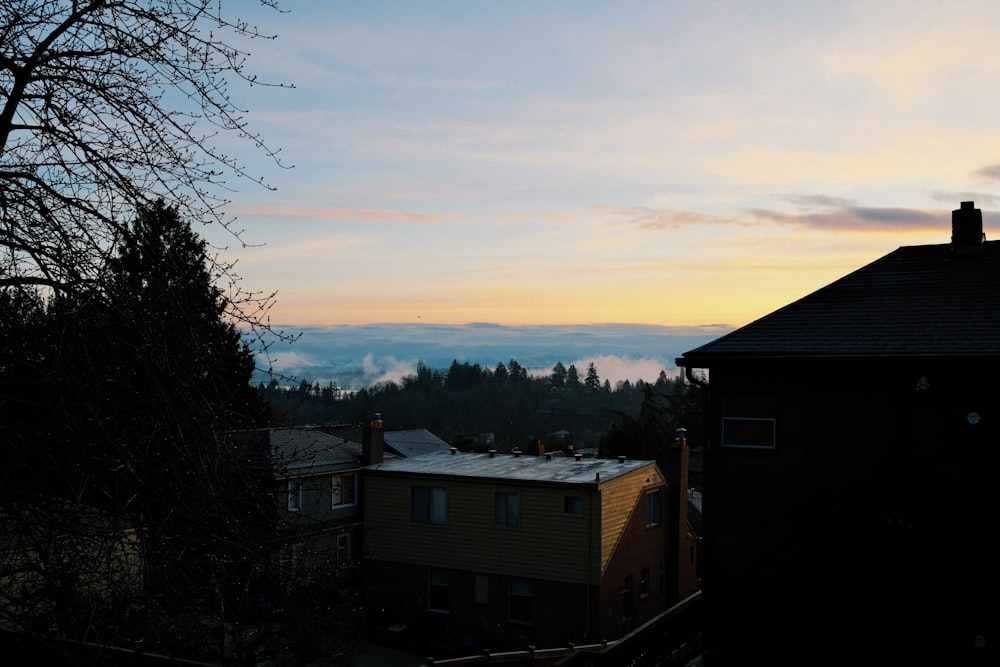 a view of a house with a sunset in the background