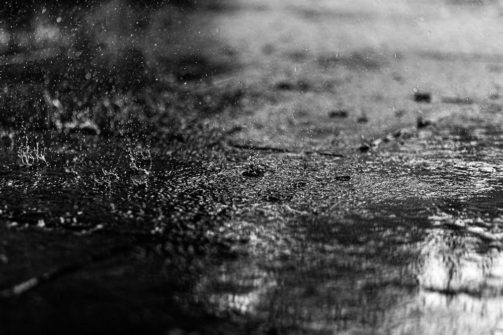 a black and white photo of a puddle of water