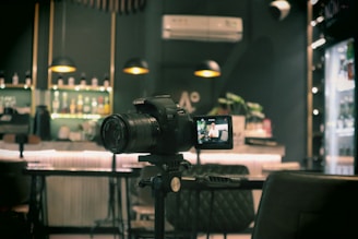 a camera sitting on top of a tripod in front of a bar