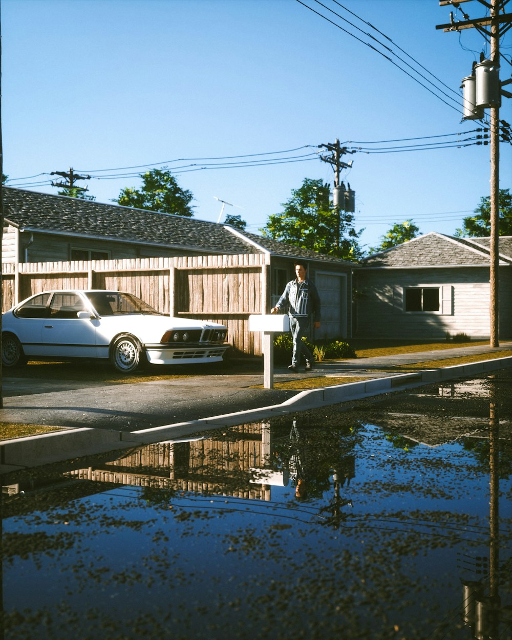 a white car parked in front of a house